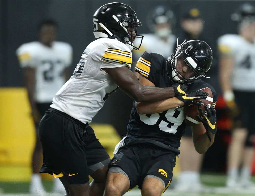 Iowa Hawkeyes defensive back Dallas Craddieth (15) and wide receiver Nico Ragaini (89) during Fall Camp Practice No. 16 Tuesday, August 20, 2019 at the Ronald D. and Margaret L. Kenyon Football Practice Facility. (Brian Ray/hawkeyesports.com)