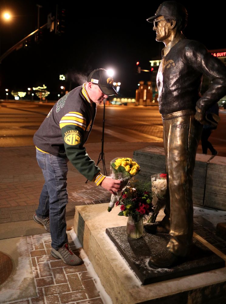 Mourners lay flowers at the statue of former Hawkeye Football Head Coach Hayden Fry Tuesday, December 17, 2019 in Coralville. Fry passed away on Tuesday at the age of 90. (Brian Ray/hawkeyesports.com)