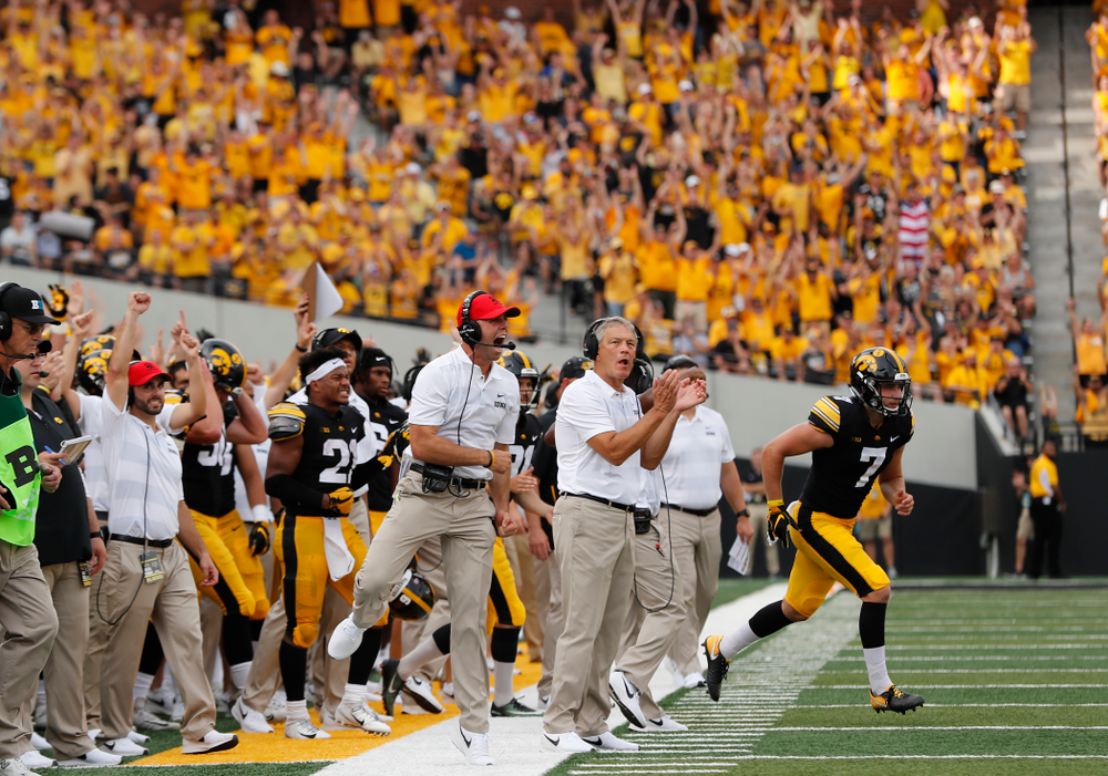 Iowa Hawkeyes head coach Kirk Ferentz and offensive student assistant Declan Doyle celebrate a touchdown against the Northern Illinois Huskies Saturday, September 1, 2018 at Kinnick Stadium. (Brian Ray/hawkeyesports.com)