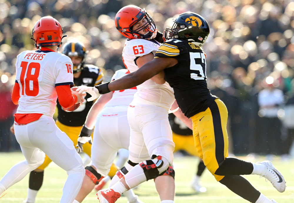 Iowa Hawkeyes defensive end Chauncey Golston (57) tries to grab Illinois Fighting Illini quarterback Brandon Peters (18) during the fourth quarter of their game at Kinnick Stadium in Iowa City on Saturday, Nov 23, 2019. (Stephen Mally/hawkeyesports.com)