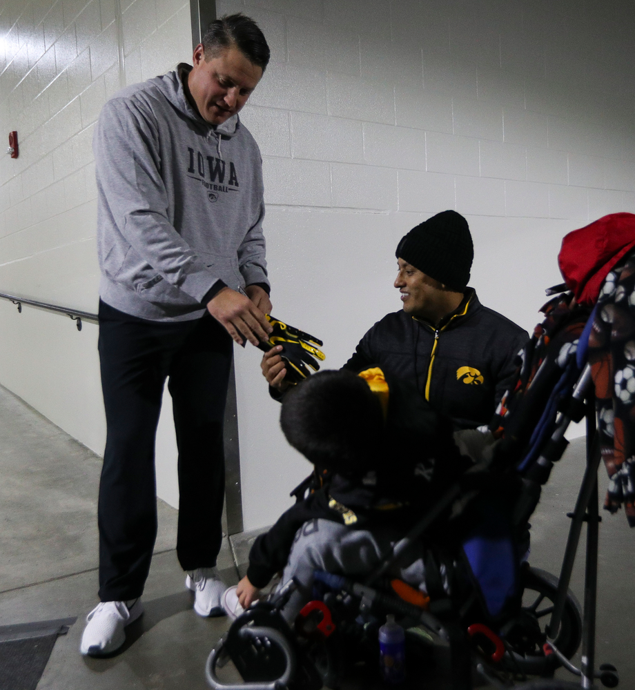 Iowa Hawkeyes offensive coordinator Brian Ferentz meets with Kid Captain Mason Gonzalez before a game against Northwestern at Kinnick Stadium on November 10, 2018. (Tork Mason/hawkeyesports.com)