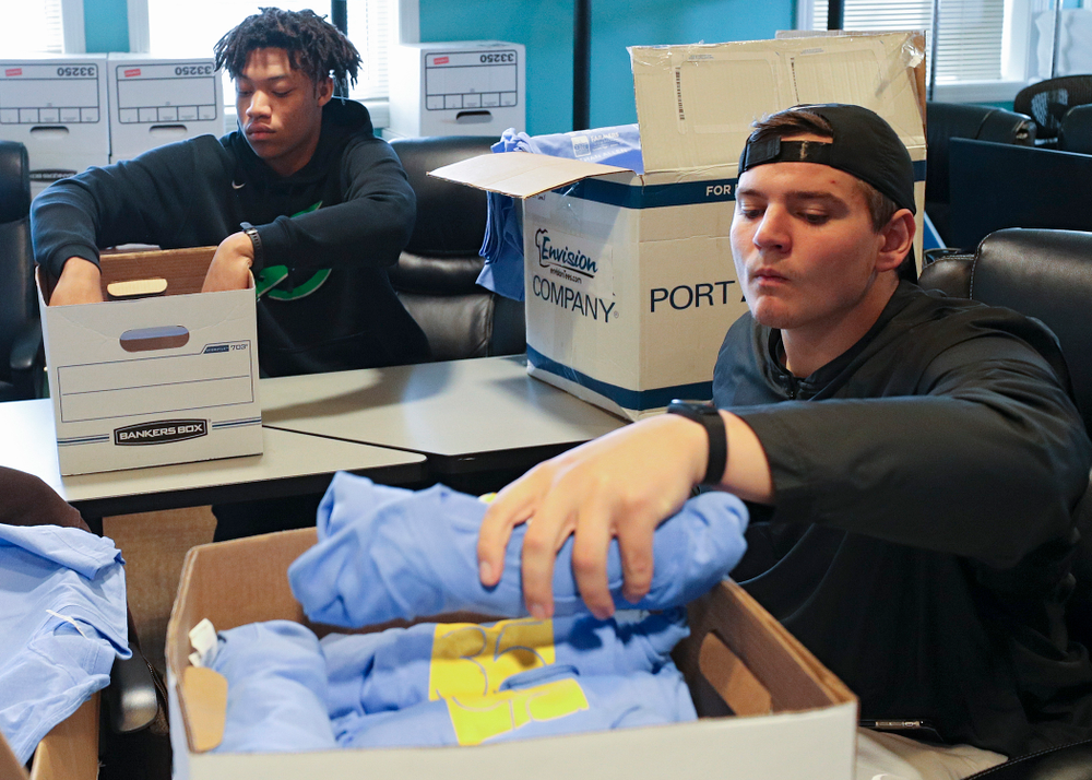 Iowa football players help fold shirts at the Ronald McDonald House for their Red Shoe Run/Walk during the 21st annual ISAAC Hawkeye Day of Caring in Iowa City on Sunday, Apr. 28, 2019. (Stephen Mally/hawkeyesports.com)