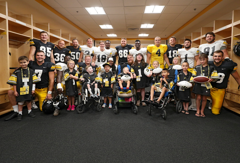 The 2019 Kid Captains with Iowa players during Kids Day at Kinnick Stadium in Iowa City on Saturday, Aug 10, 2019. (Stephen Mally/hawkeyesports.com)