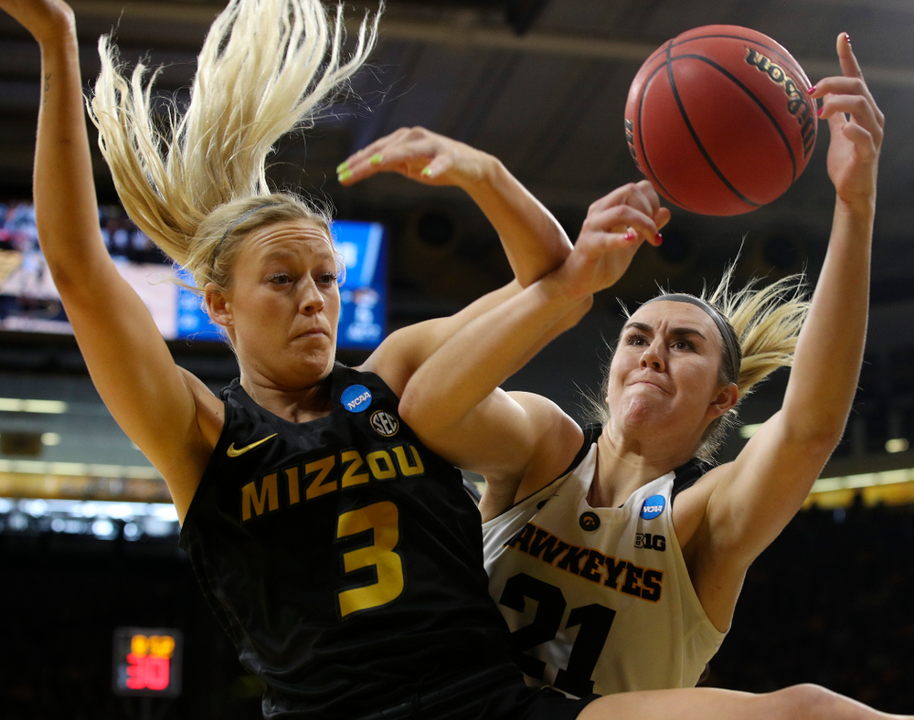 Iowa Hawkeyes forward Hannah Stewart (21) tries to pull in a rebound around Missouri Tigers guard Sophie Cunningham (3) during the first quarter of their second round game in the 2019 NCAA Women's Basketball Tournament at Carver Hawkeye Arena in Iowa City on Sunday, Mar. 24, 2019. (Stephen Mally for hawkeyesports.com)