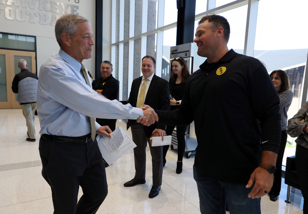 ANF Honoree Matt Kroul shakes hands with Iowa Hawkeyes head coach Kirk Ferentz Tuesday, October 8, 2019 at the Hansen Football Performance Center. (Brian Ray/hawkeyesports.com)
