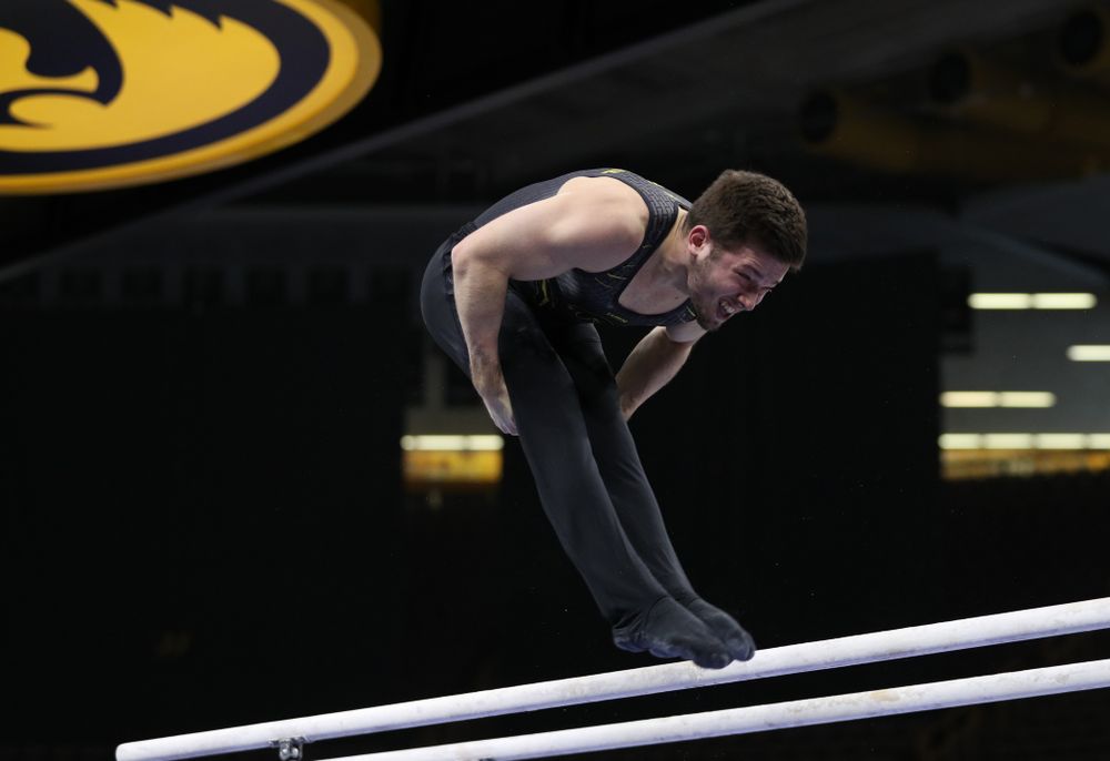 Iowa's Rogelio Vazquez competes on the parallel bars against the Ohio State Buckeyes Saturday, March 16, 2019 at Carver-Hawkeye Arena. (Brian Ray/hawkeyesports.com)