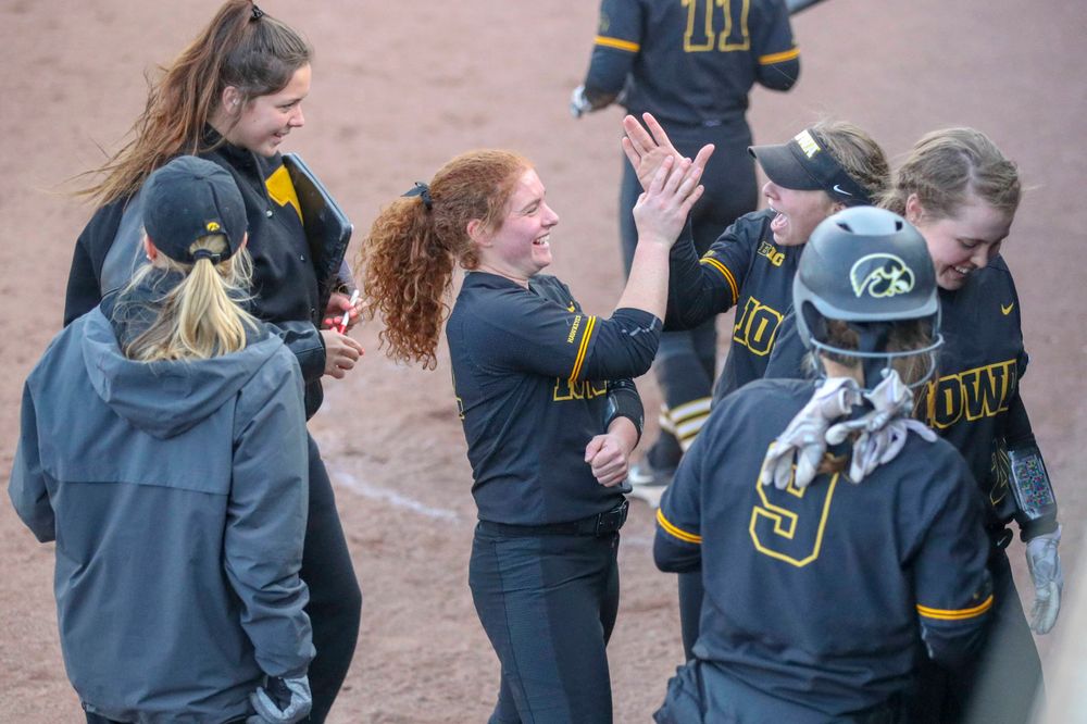 IowaÕs Kate Claypool (12) and IowaÕs Miranda Schulte (20) at softball vs Illinois game 3 on Saturday, April 13, 2019 at Bob Pearl Field. (Lily Smith/hawkeyesports.com)