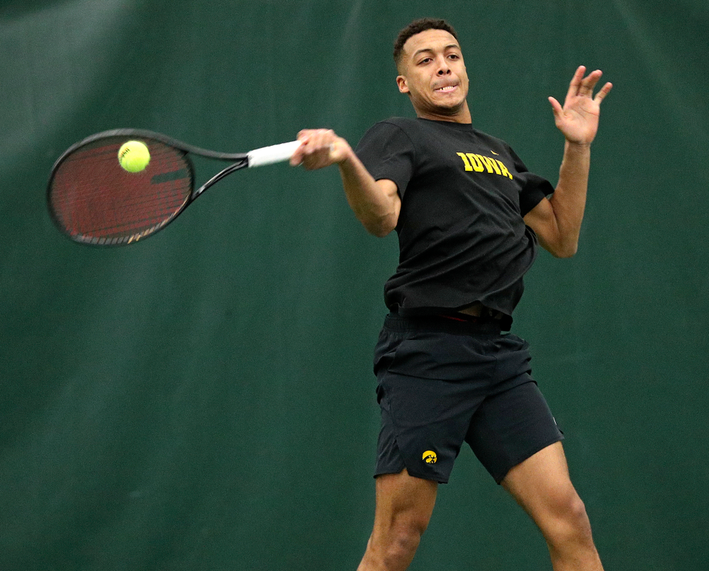 Iowa’s Oliver Okonkwo returns a shot during his singles match at the Hawkeye Tennis and Recreation Complex in Iowa City on Friday, February 14, 2020. (Stephen Mally/hawkeyesports.com)