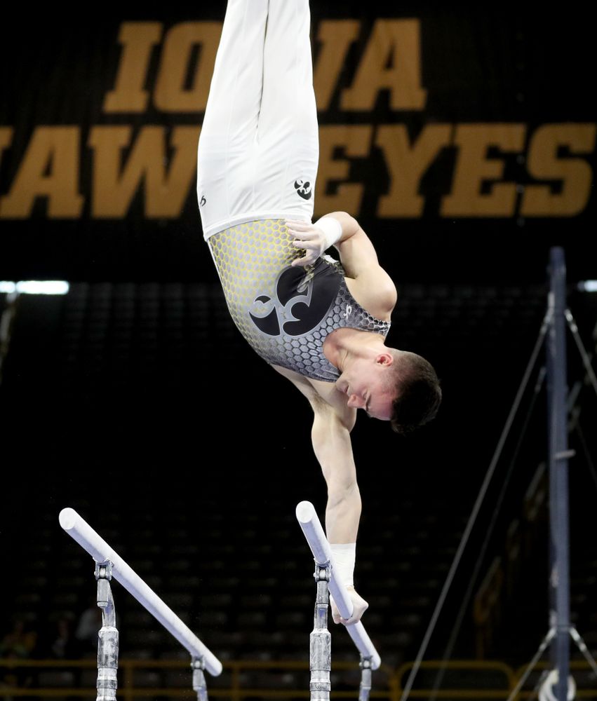 Iowa’s Mitch Mandozzi competes on the parallel bars against Illinois Sunday, March 1, 2020 at Carver-Hawkeye Arena. (Brian Ray/hawkeyesports.com)
