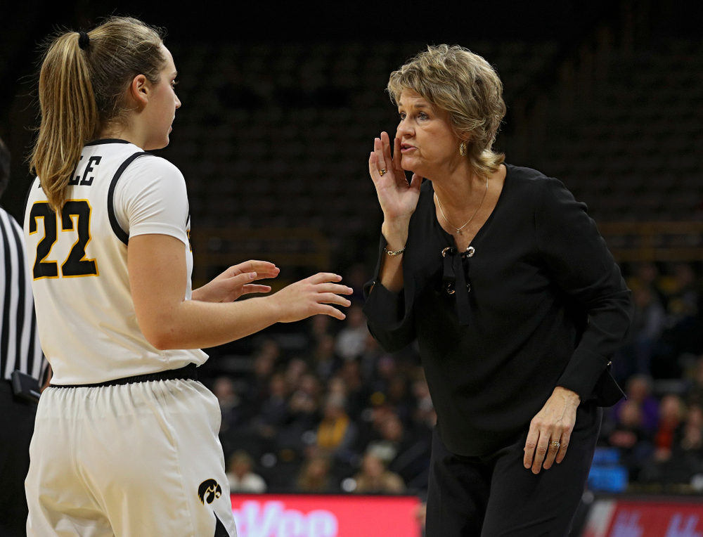 Iowa head coach Lisa Bluder (right) talks with guard Kathleen Doyle (22) during the third quarter of their overtime win against Princeton at Carver-Hawkeye Arena in Iowa City on Wednesday, Nov 20, 2019. (Stephen Mally/hawkeyesports.com)