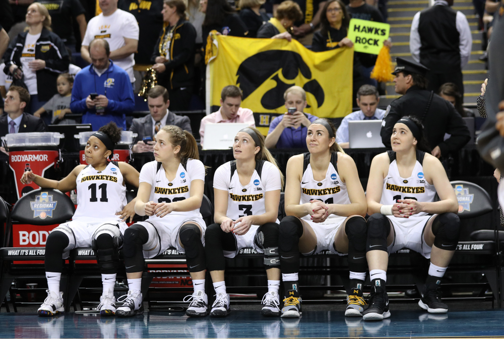 Iowa Hawkeyes starters Tania Davis, guard Kathleen Doyle (22), i3#3, forward Hannah Stewart (21), and Megan Gustafson against the NC State Wolfpack in the regional semi-final of the 2019 NCAA Women's College Basketball Tournament Saturday, March 30, 2019 at Greensboro Coliseum in Greensboro, NC.(Brian Ray/hawkeyesports.com)