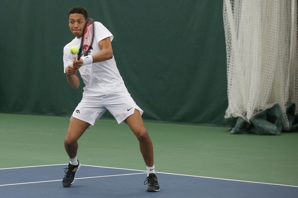 Iowa’s Oliver Okonkwo returns a hit during the Iowa men’s tennis meet vs Nebraska on Sunday, March 1, 2020 at the Hawkeye Tennis and Recreation Complex. (Lily Smith/hawkeyesports.com)