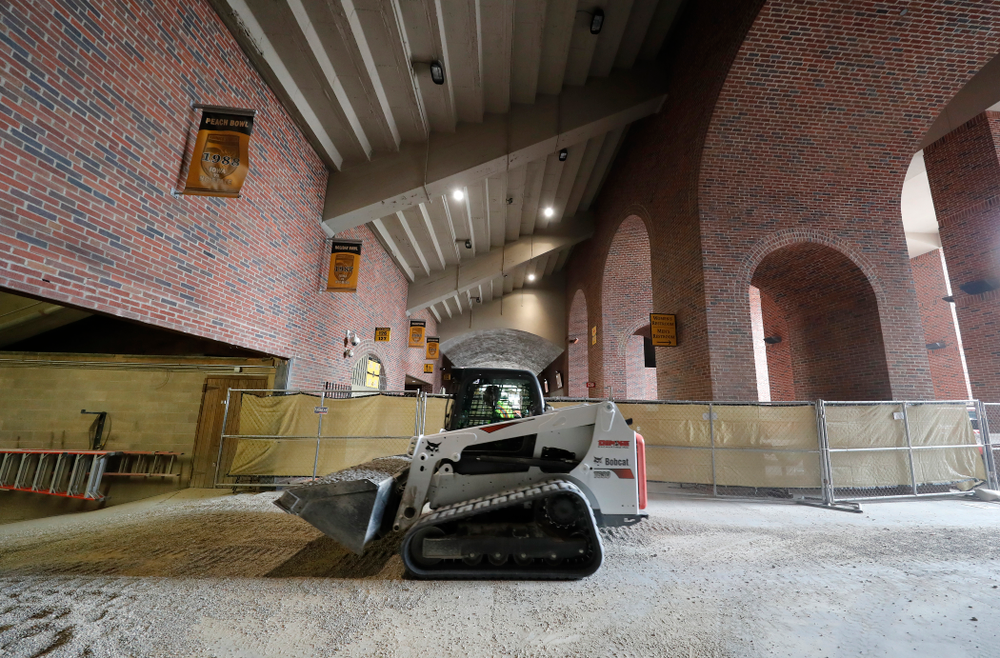 Workers haul gravel down the the field Wednesday, June 6, 2018 at Kinnick Stadium. (Brian Ray/hawkeyesports.com)