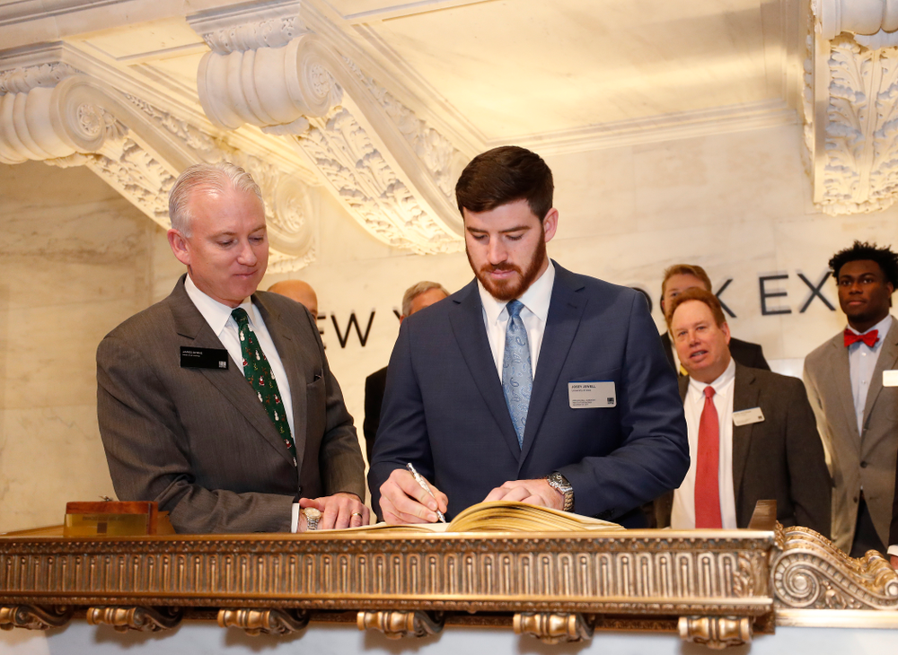 Iowa Hawkeyes linebacker Josey Jewell (43), defensive back Joshua Jackson (15), offensive lineman Sean Welsh (79) and head coach Kirk Ferentz ring the opening bell at the New York Stock Exchange Tuesday, December 26, 2017 in New York. (Brian Ray/hawkeyesports.com)