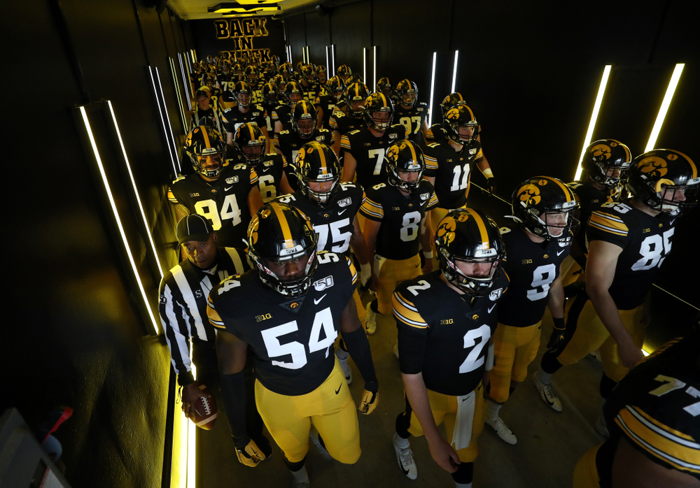 The Iowa Hawkeyes swarm to the field for their game against the Purdue Boilermakers Saturday, October 19, 2019 at Kinnick Stadium. (Brian Ray/hawkeyesports.com)