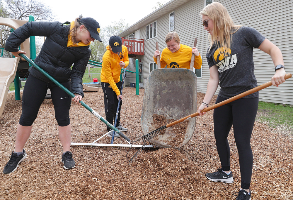 Iowa field hockey players re-mulch the playground at the HACAP Coral Ridge Head Start Center during the 21st annual ISAAC Hawkeye Day of Caring in Coralville on Sunday, Apr. 28, 2019. (Stephen Mally/hawkeyesports.com)