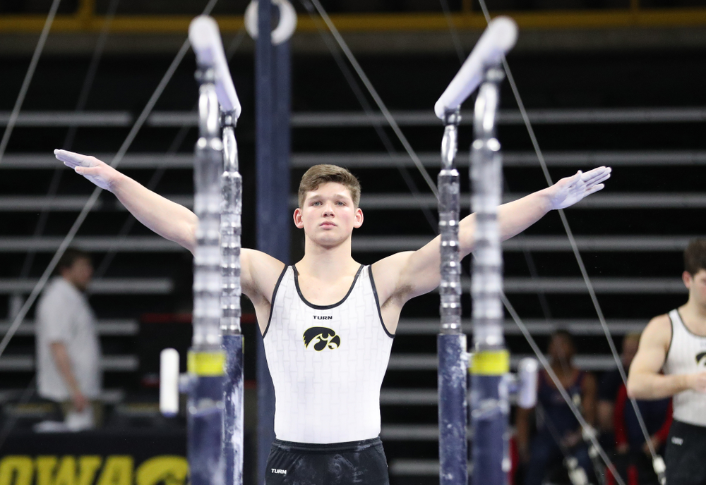 Iowa's Stewart Brown competes on the parallel bars against UIC and Minnesota Saturday, February 2, 2019 at Carver-Hawkeye Arena. (Brian Ray/hawkeyesports.com)