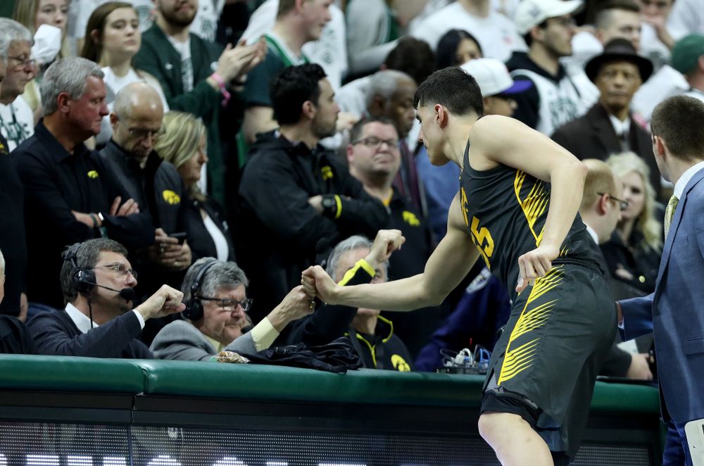 Iowa Hawkeyes forward Luka Garza (55) fist bumps Gary Dolphin against Michigan State Tuesday, February 25, 2020 at the Breslin Center in East Lansing, MI. (Brian Ray/hawkeyesports.com)
