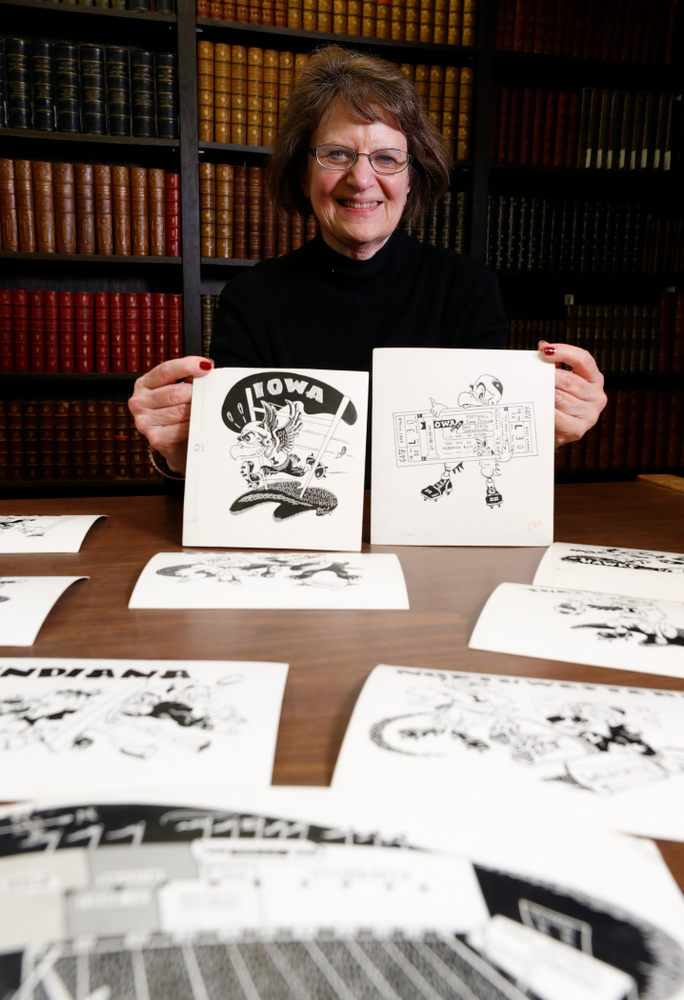 Jane Roth sits with some of the original drawings of Herky the Hawk Friday, April 20, 2018 at the University of Iowa Library. Roth has donated the drawings, which were created by artist Dick Spencer, to the library's special collection. (Brian Ray/hawkeyesports.com)