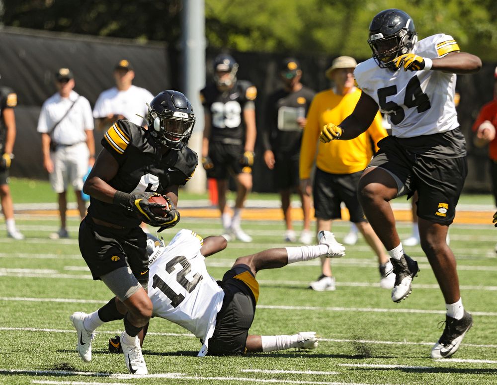 Iowa Hawkeyes wide receiver Ihmir Smith-Marsette (6) pulls in a pass around defensive back D.J. Johnson (12) and defensive tackle Daviyon Nixon (54) during Fall Camp Practice No. 7 at the Hansen Football Performance Center in Iowa City on Friday, Aug 9, 2019. (Stephen Mally/hawkeyesports.com)