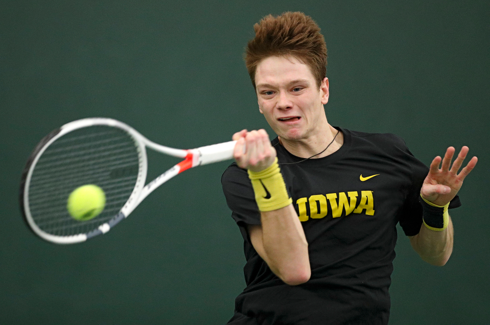 Iowa’s Jason Kerst hits a shot during his match against Marquette at the Hawkeye Tennis and Recreation Complex in Iowa City on Saturday, January 25, 2020. (Stephen Mally/hawkeyesports.com)