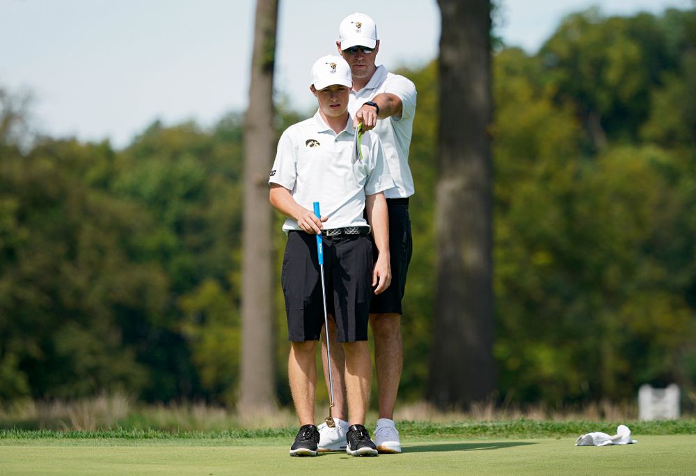 Iowa’s Matthew Garside (from left) talks with head coach Tyler Stith during the second day of the Golfweek Conference Challenge at the Cedar Rapids Country Club in Cedar Rapids on Monday, Sep 16, 2019. (Stephen Mally/hawkeyesports.com)
