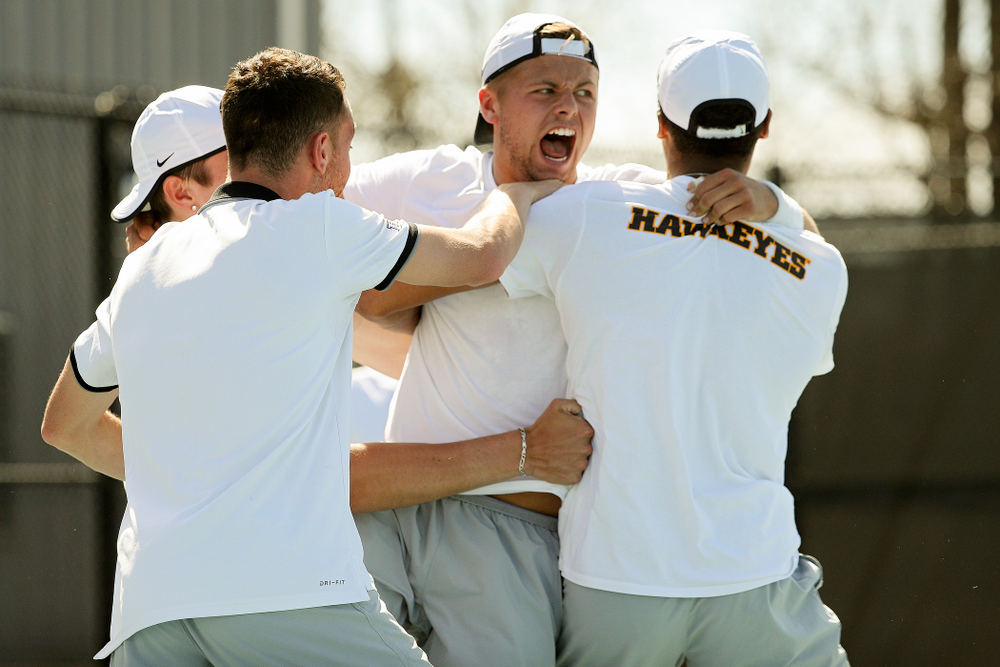Iowa's Will Davies celebrates with teammates after winning his match against Michigan at the Hawkeye Tennis and Recreation Complex in Iowa City on Sunday, Apr. 21, 2019. (Stephen Mally/hawkeyesports.com)