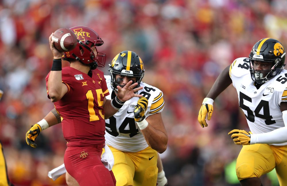 Iowa Hawkeyes defensive end A.J. Epenesa (94) and Iowa Hawkeyes defensive tackle Daviyon Nixon (54) put pressure on Iowa State Cyclones quarterback Brock Purdy (15) Saturday, September 14, 2019 at Jack Trice Stadium in Ames, Iowa. (Brian Ray/hawkeyesports.com)