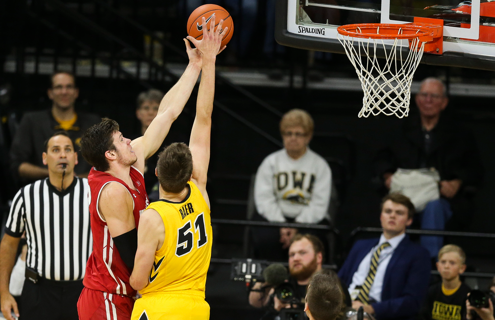 Iowa Hawkeyes forward Nicholas Baer (51) blocks a shot by Wisconsin's Ethan Happ on November 30, 2018 at Carver-Hawkeye Arena. (Tork Mason/hawkeyesports.com)
