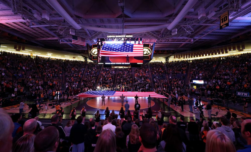 Members of the military spread out a large flag during the National Anthem before the Iowa Hawkeyes meet against Minnesota Saturday, February 15, 2020 at Carver-Hawkeye Arena. (Brian Ray/hawkeyesports.com)