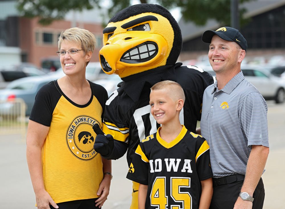 A family takes a picture with Herky during Kids Day at Kinnick Stadium in Iowa City on Saturday, Aug 10, 2019. (Stephen Mally/hawkeyesports.com)