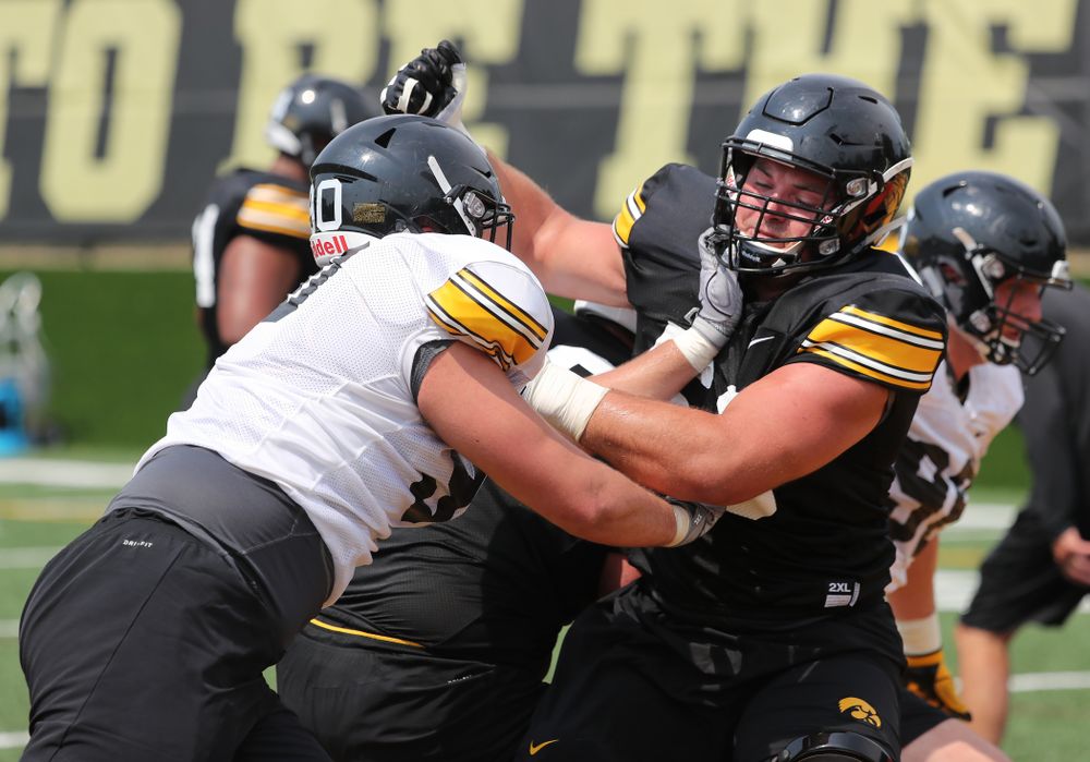 Iowa Hawkeyes offensive lineman Ross Reynolds (59) and defensive end Sam Brincks (90) during the third practice of fall camp Sunday, August 5, 2018 at the Kenyon Football Practice Facility. (Brian Ray/hawkeyesports.com)