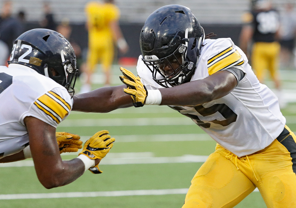 Iowa Hawkeyes linebacker Yahweh Jeudy (55) eyes linebacker Djimon Colbert (32) as they run a drill during Fall Camp Practice No. 12 at Kinnick Stadium in Iowa City on Thursday, Aug 15, 2019. (Stephen Mally/hawkeyesports.com)