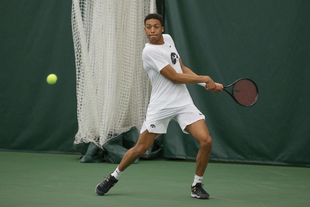 Iowa’s Oliver Okonkwo returns a hit during the Iowa men’s tennis meet vs Nebraska on Sunday, March 1, 2020 at the Hawkeye Tennis and Recreation Complex. (Lily Smith/hawkeyesports.com)