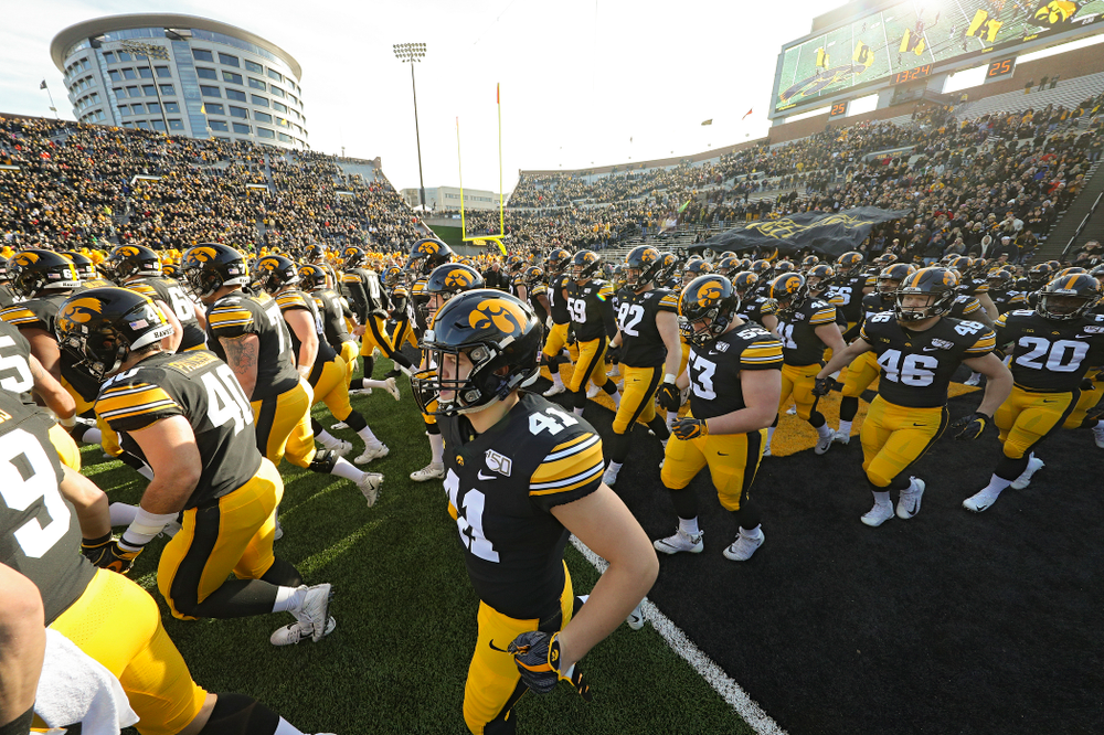 The Iowa Hawkeyes swarm as they take the field before their game at Kinnick Stadium in Iowa City on Saturday, Nov 23, 2019. (Stephen Mally/hawkeyesports.com)