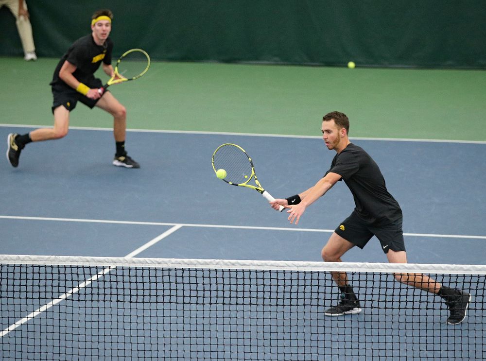 Iowa’s Kareem Allaf (right) hits a shot as Nikita Snezhko looks on during their doubles match against Marquette at the Hawkeye Tennis and Recreation Complex in Iowa City on Saturday, January 25, 2020. (Stephen Mally/hawkeyesports.com)