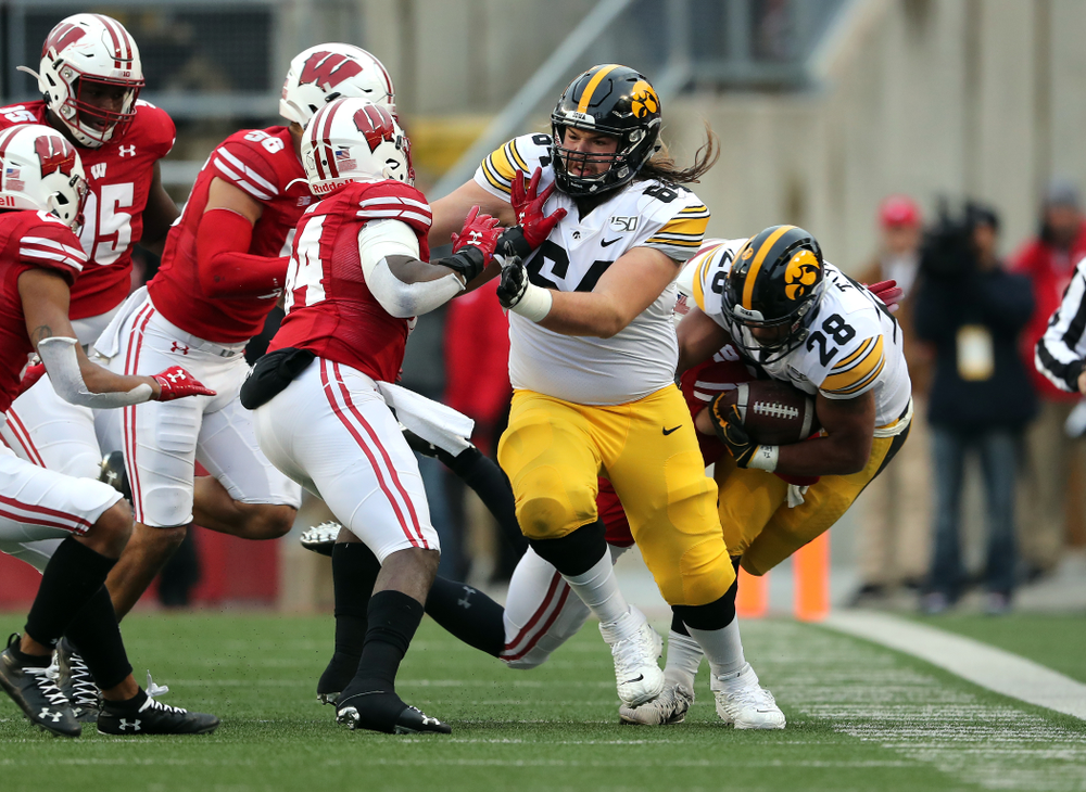 Iowa Hawkeyes offensive lineman Kyler Schott (64) and running back Toren Young (28) against the Wisconsin Badgers Saturday, November 9, 2019 at Camp Randall Stadium in Madison, Wisc. (Brian Ray/hawkeyesports.com)