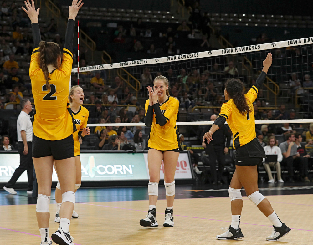 Iowa’s Courtney Buzzerio (2), Kyndra Hansen (8), Hannah Clayton (18), and Brie Orr (7) celebrate a score during their match at Carver-Hawkeye Arena in Iowa City on Sunday, Oct 20, 2019. (Stephen Mally/hawkeyesports.com)