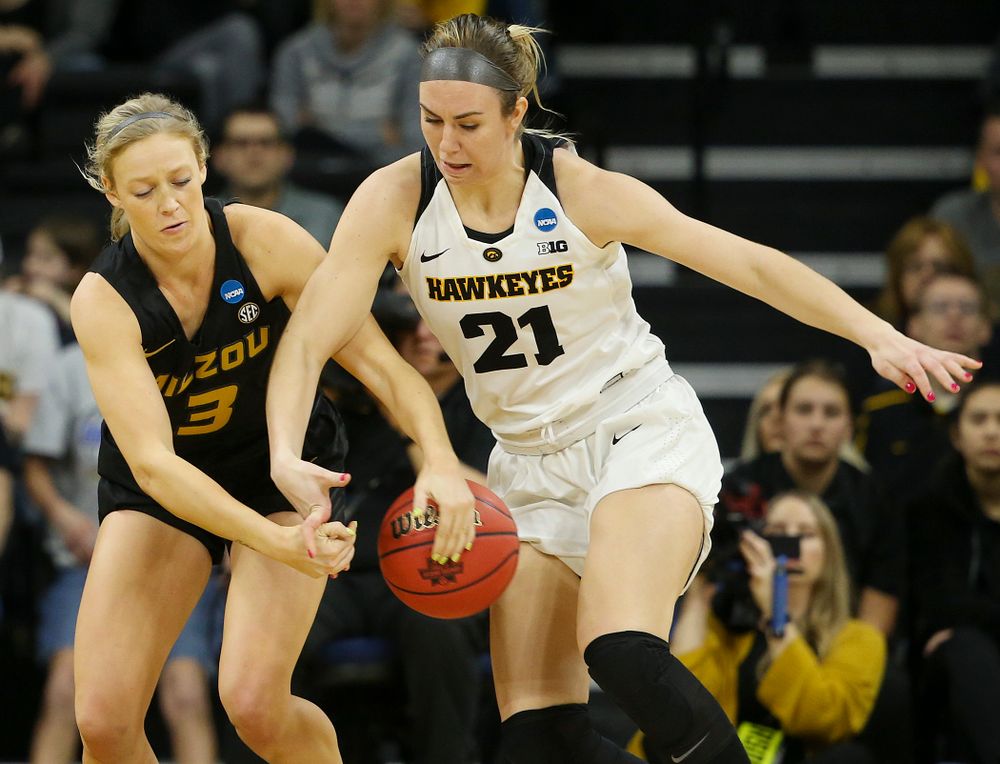 Missouri Tigers guard Sophie Cunningham (3) and Iowa Hawkeyes forward Hannah Stewart (21) battle for a loose ball during the third quarter of their second round game in the 2019 NCAA Women's Basketball Tournament at Carver Hawkeye Arena in Iowa City on Sunday, Mar. 24, 2019. (Stephen Mally for hawkeyesports.com)