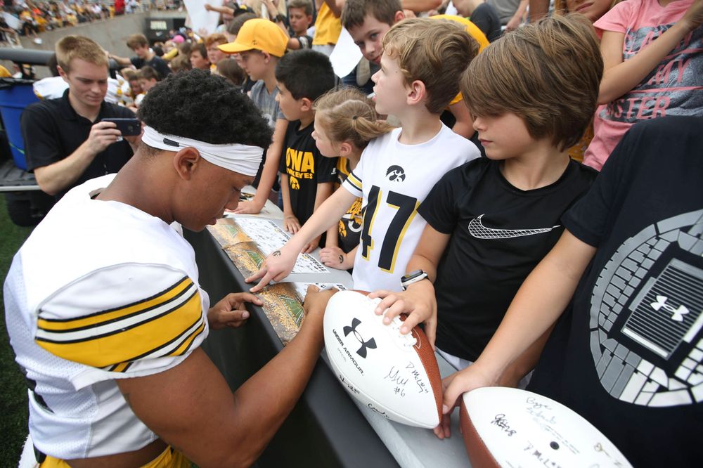 Iowa Hawkeyes defensive back Daraun McKinney (14) signs autographs during Kids Day at Kinnick Stadium on Saturday, August 10, 2019. (Lily Smith/hawkeyesports.com)
