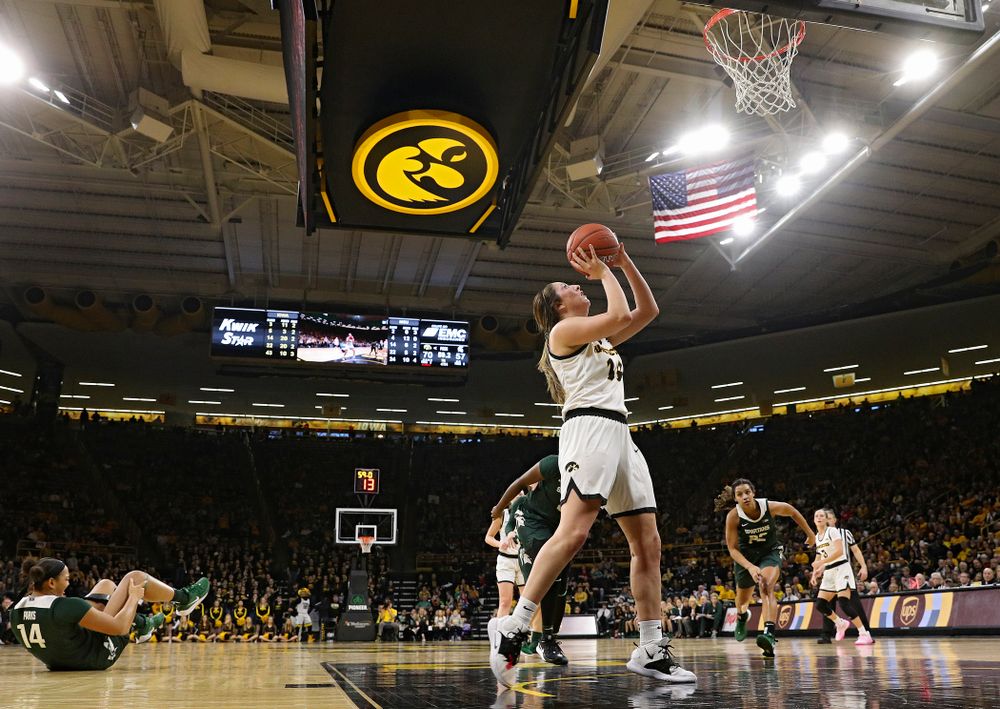 Iowa Hawkeyes guard Mckenna Warnock (14) makes a basket while being fouled during the fourth quarter of their game at Carver-Hawkeye Arena in Iowa City on Sunday, January 26, 2020. (Stephen Mally/hawkeyesports.com)
