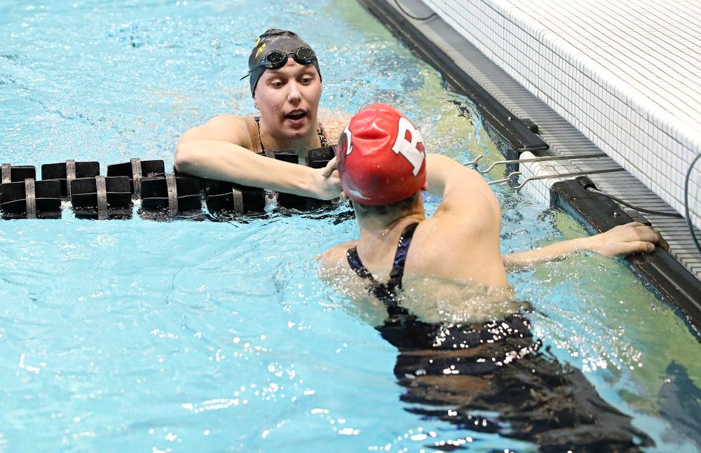 Iowa’s Allyssa Fluit (top) shakes hands with Rutger’s Francesca Bertotto after swimming the women’s 500 yard freestyle preliminary event during the 2020 Women’s Big Ten Swimming and Diving Championships at the Campus Recreation and Wellness Center in Iowa City on Thursday, February 20, 2020. (Stephen Mally/hawkeyesports.com)