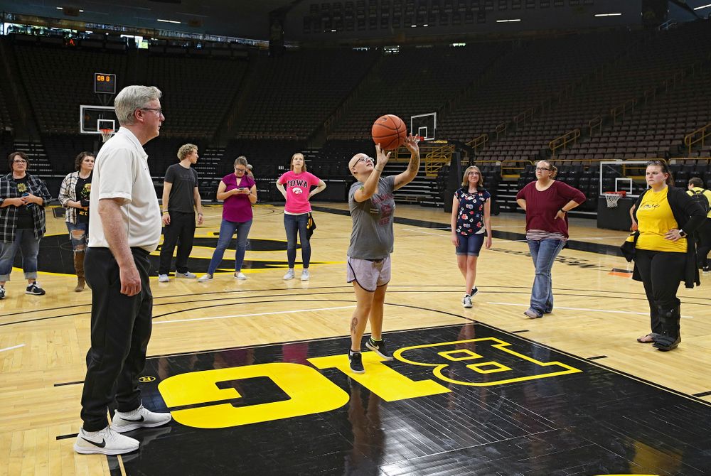 Iowa Hawkeyes head coach Fran McCaffery looks on as visitors from the University of Iowa Hospitals and Clinics Adolescent and Young Adult (AYA) Cancer Program shoot baskets at Carver-Hawkeye Arena in Iowa City on Monday, Sep 30, 2019. (Stephen Mally/hawkeyesports.com)