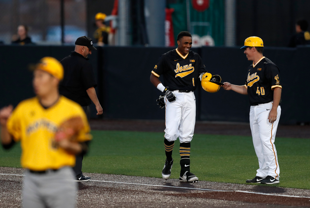 Iowa Hawkeyes third baseman Lorenzo Elion (1) and volunteer coach Sean Moore against Milwaukee Wednesday, April 25, 2018 at Duane Banks Field. (Brian Ray/hawkeyesports.com)
