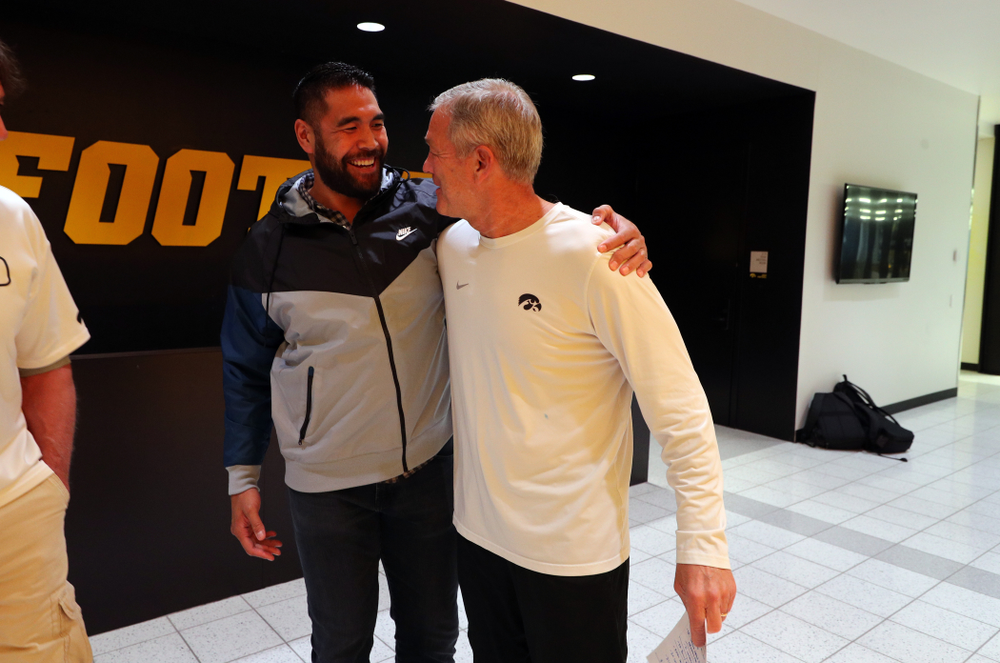 Iowa Hawkeyes head coach Kirk Ferentz talks with former tight end Tony Moeaki Friday, October 11, 2019 at the Hansen Football Performance Center. (Brian Ray/hawkeyesports.com)