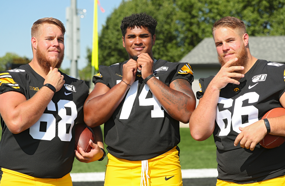 Iowa Hawkeyes offensive lineman Landan Paulsen (68), offensive lineman Tristan Wirfs (74), and offensive lineman Levi Paulsen (66) show off their beards during Iowa Football Media Day at the Hansen Football Performance Center in Iowa City on Friday, Aug 9, 2019. (Stephen Mally/hawkeyesports.com)