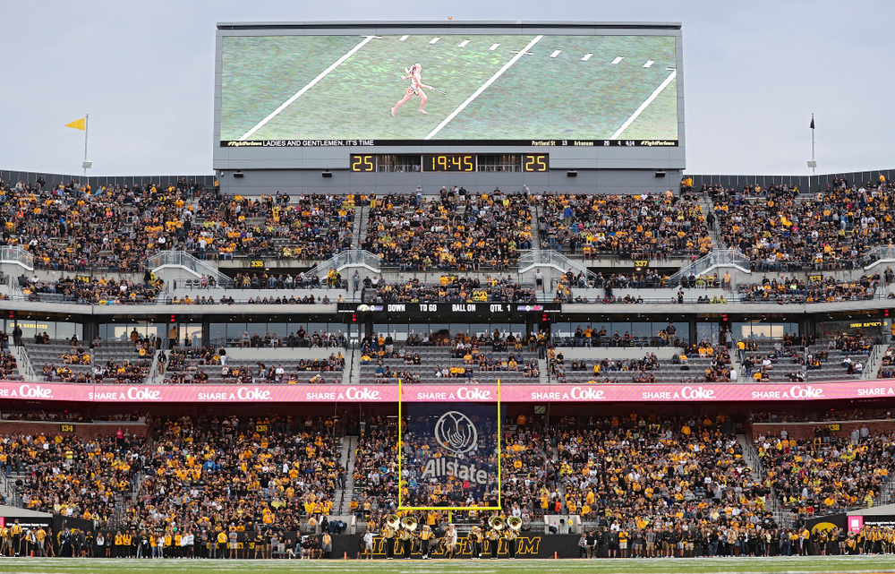 Unversity of Iowa Golden Girl Kylene Spanbauer leads the Hawkeye Marching Band onto the field before the game at Kinnick Stadium in Iowa City on Saturday, Aug 31, 2019. (Stephen Mally/hawkeyesports.com)