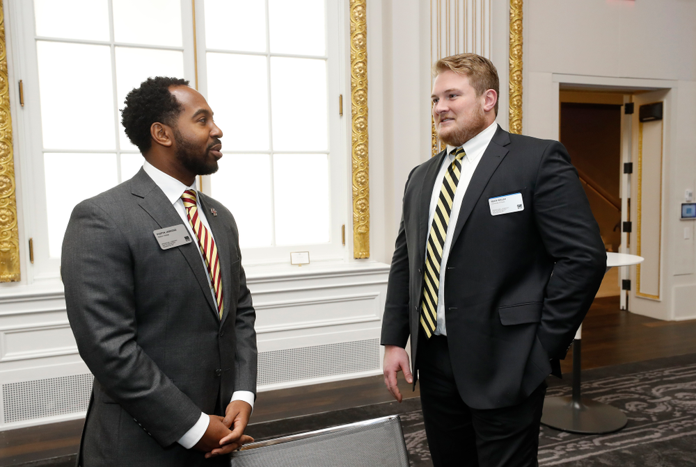 Iowa Hawkeyes linebacker Josey Jewell (43), defensive back Joshua Jackson (15), offensive lineman Sean Welsh (79) and head coach Kirk Ferentz ring the opening bell at the New York Stock Exchange Tuesday, December 26, 2017 in New York. (Brian Ray/hawkeyesports.com)