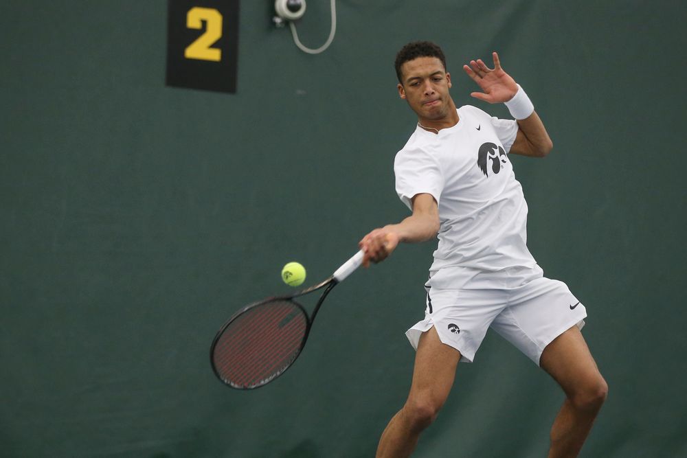 Iowa’s Oliver Okonkwo returns a hit during the Iowa men’s tennis meet vs Nebraska on Sunday, March 1, 2020 at the Hawkeye Tennis and Recreation Complex. (Lily Smith/hawkeyesports.com)