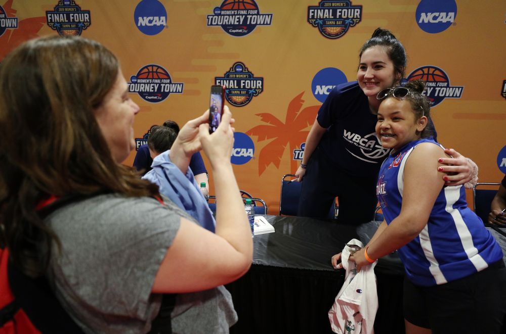 Iowa Hawkeyes forward Megan Gustafson (10) signs autographs with the other WBCA All Americans at the Tourney Town Fan Fest Friday, April 5, 2019 at the Tampa Convention Center in Tampa, FL. (Brian Ray/hawkeyesports.com)
